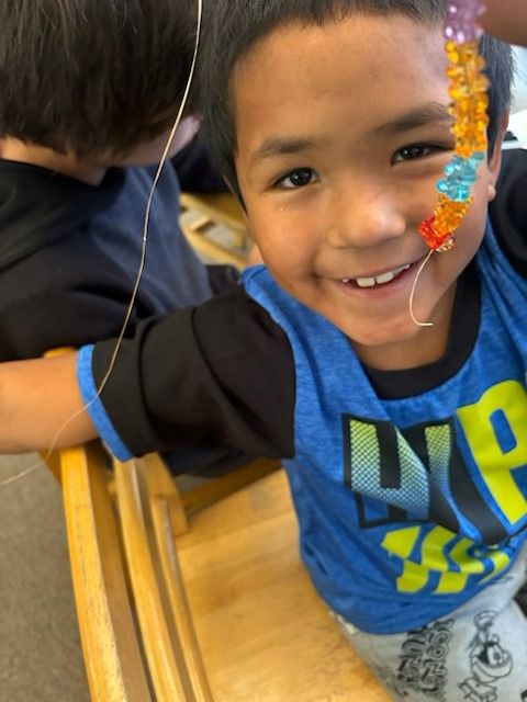 Child making necklace 