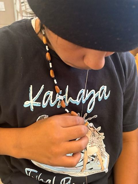 Child making necklace