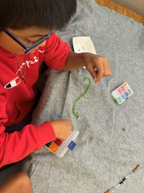 Child making necklace